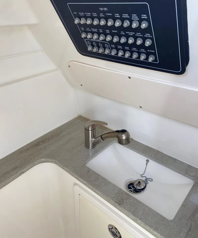 Slide: The Image of 2017 Boston Whaler 320 Vantage boat interior with sink and control panel. - 37