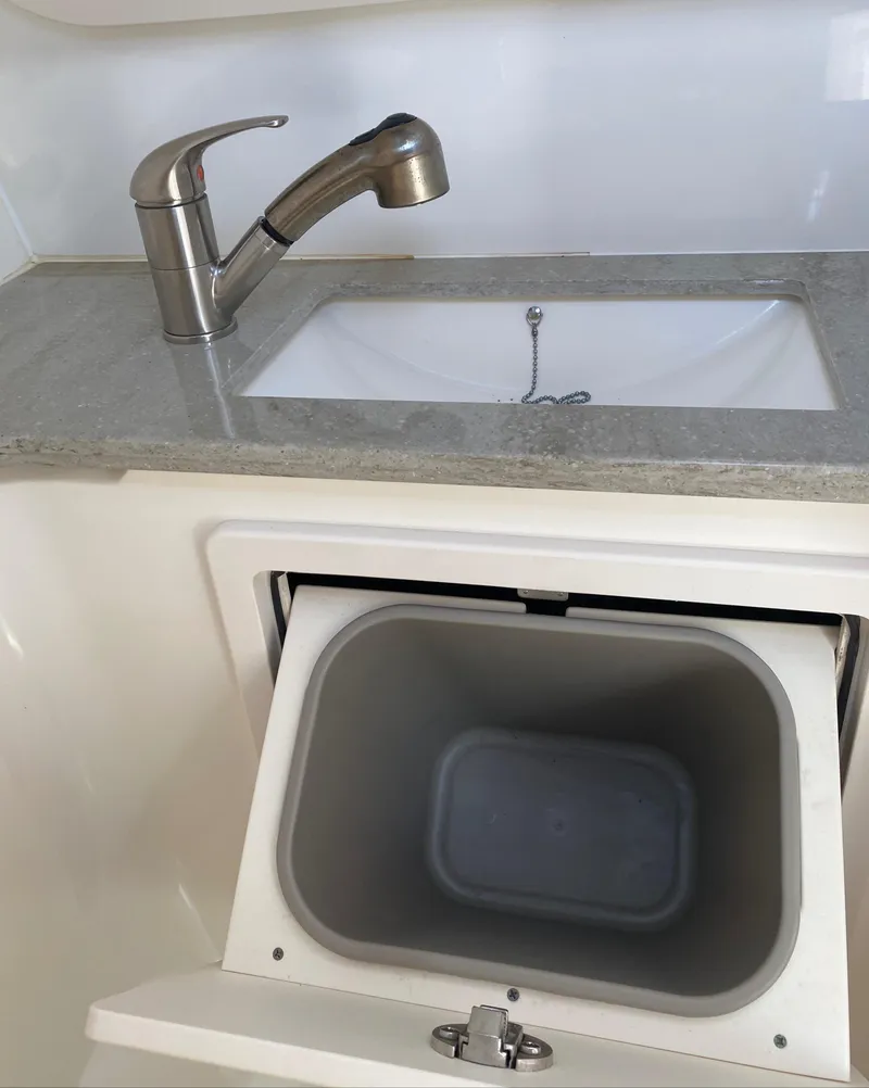 Slide: The Image of 2017 Boston Whaler 320 Vantage sink and storage compartment detail. - 38