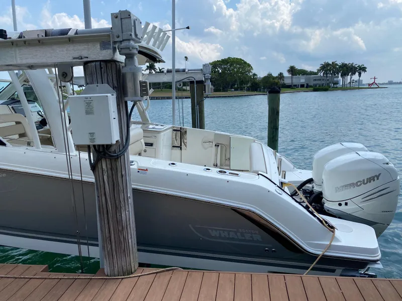 Slide: The Image of 2017 Boston Whaler 320 Vantage docked by the water with Mercury outboard engine. - 4