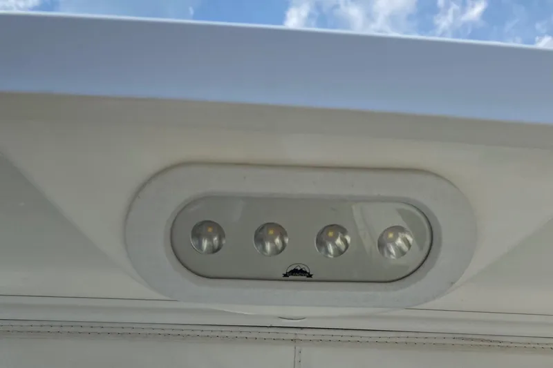 Slide: The Image of LED light fixture on a 2017 Boston Whaler 320 Vantage boat, under a clear blue sky. - 45
