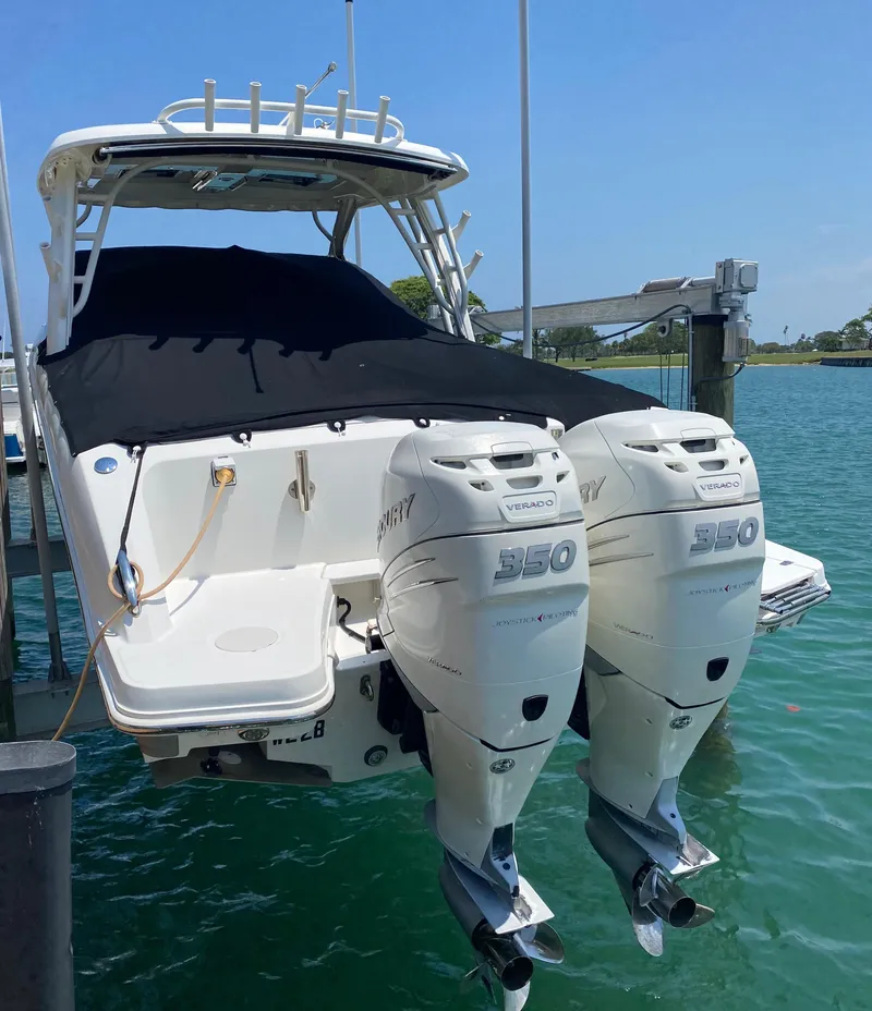 Slide: The Image of 2017 Boston Whaler 320 Vantage with twin Mercury engines docked on clear water. - 6