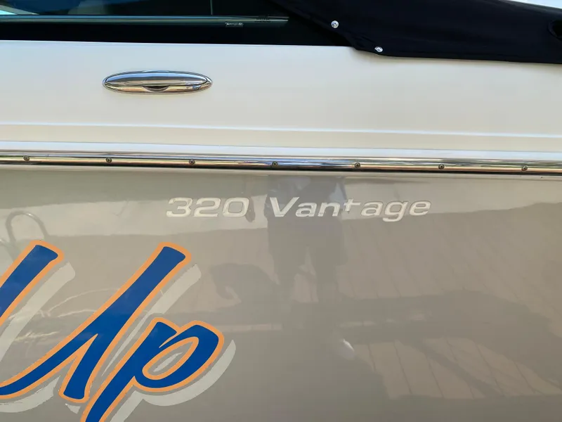 Slide: The Image of 2017 Boston Whaler 320 Vantage boat side view with model name visible. - 7