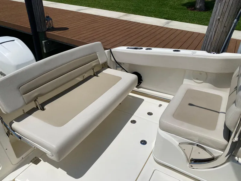 Slide: The Image of 2017 Boston Whaler 320 Vantage boat seating area with beige cushions and sleek design. - 9
