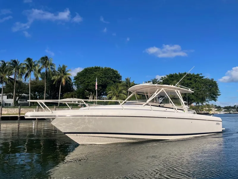 Slide: The Image of 2007 Intrepid 35 Walkaround boat on calm water, surrounded by palm trees and blue sky. - 1