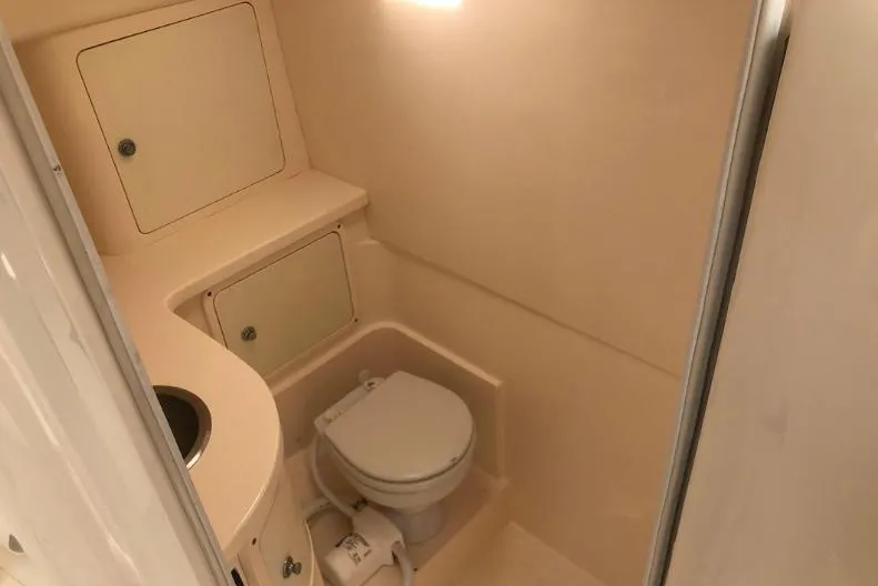 Slide: The Image of 2007 Intrepid 35 Walkaround boat bathroom with toilet and storage compartments. - 10