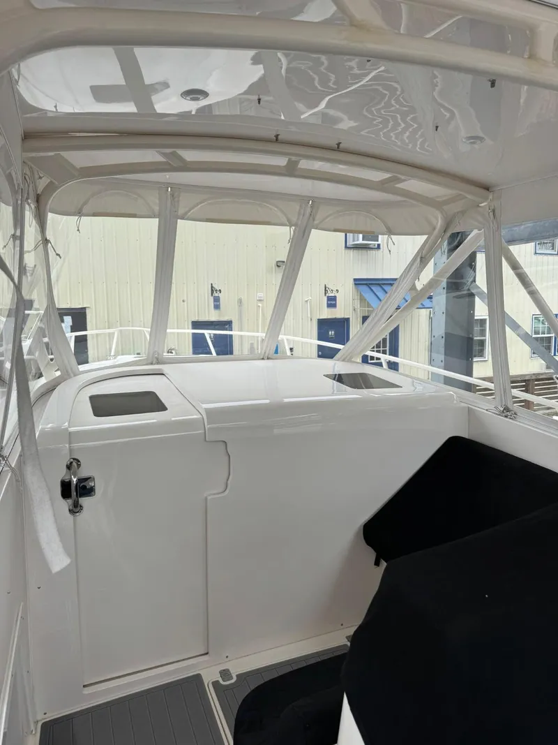 Slide: The Image of 2007 Intrepid 35 Walkaround boat interior with white and black seating. - 14