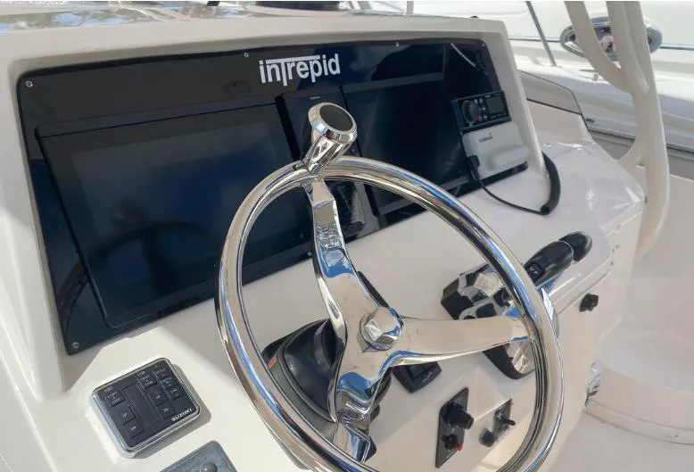 Slide: The Image of 2007 Intrepid 35 Walkaround helm with steering wheel and control panel. - 2