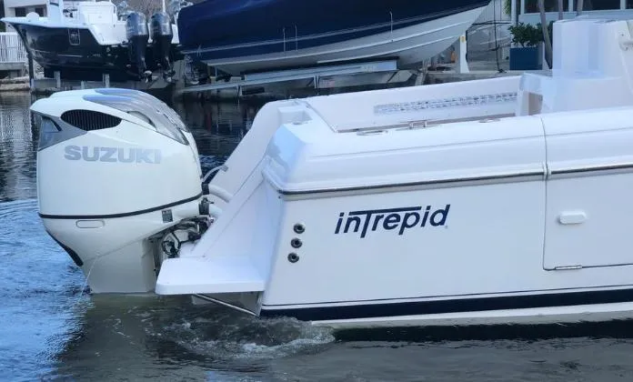 Slide: The Image of 2007 Intrepid 35 Walkaround boat with Suzuki outboard engine in water. - 28