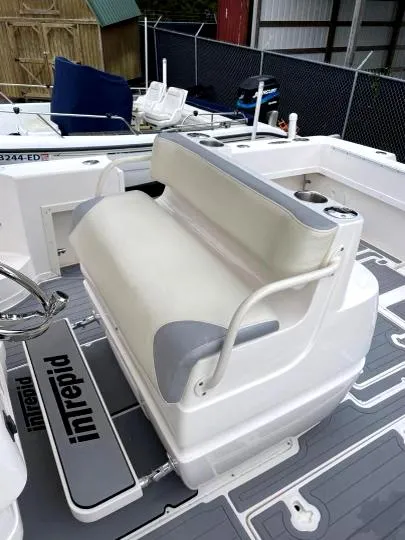 Slide: The Image of 2007 Intrepid 35 Walkaround boat interior with cushioned seating and branded flooring. - 7
