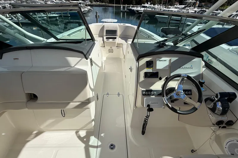 Slide: The Image of 2015 Boston Whaler 270 Vantage boat interior with Garmin navigation system and steering wheel. - 15