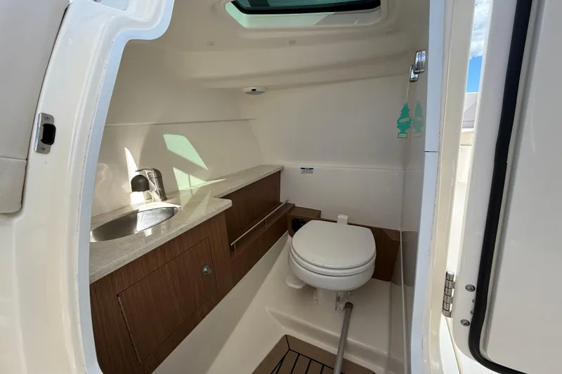 Slide: The Image of 2015 Boston Whaler 270 Vantage boat interior with sink and toilet. - 17