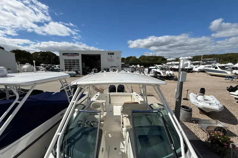 Slide: The Image of 2015 Boston Whaler 270 Vantage boat at a marina under a blue sky. - 20