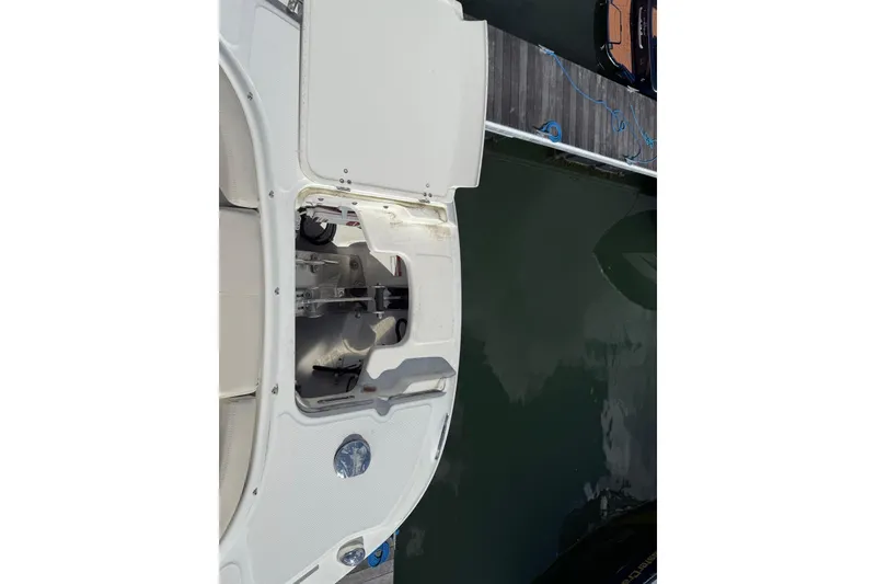 Slide: The Image of 2015 Boston Whaler 270 Vantage boat docked, showing open storage compartment. - 21