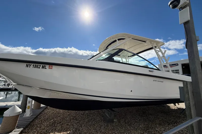 Slide: The Image of 2015 Boston Whaler 270 Vantage boat docked under sunny sky. - 23