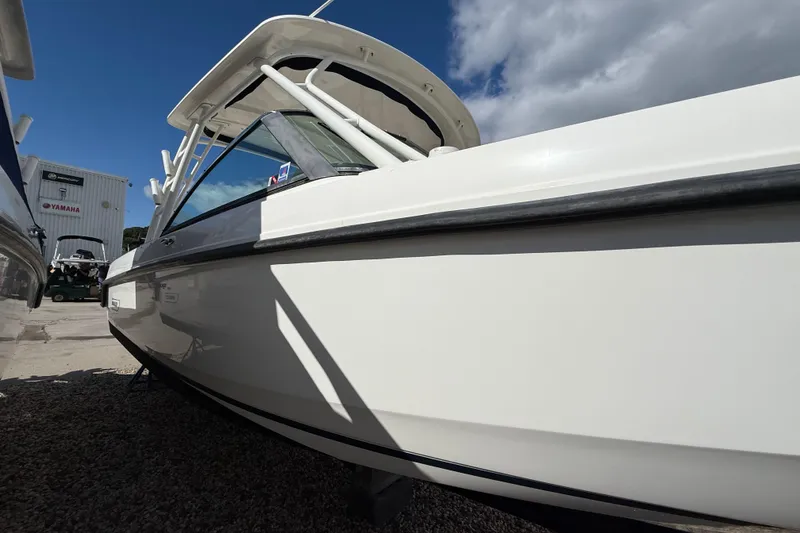 Slide: The Image of 2015 Boston Whaler 270 Vantage boat in marina, clear sky background. - 24