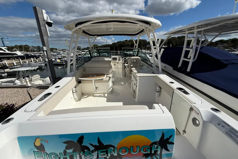 Slide: The Image of 2015 Boston Whaler 270 Vantage boat docked at marina under cloudy sky. - 3