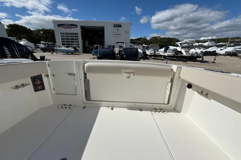 Slide: The Image of 2015 Boston Whaler 270 Vantage boat interior at marina with clear sky. - 4