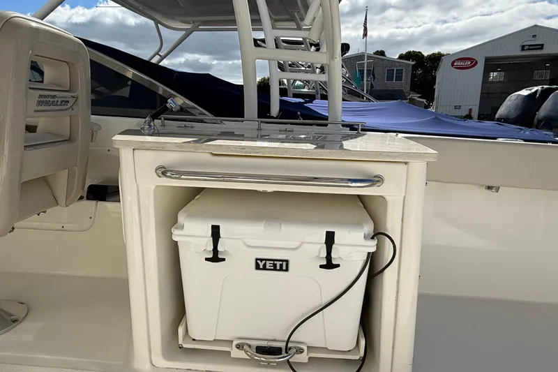 Slide: The Image of 2015 Boston Whaler 270 Vantage boat interior with Yeti cooler storage. - 7