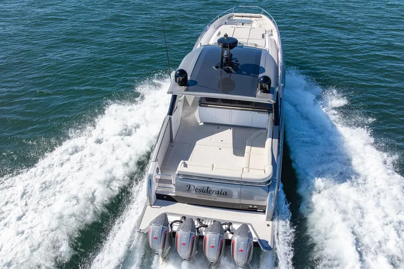 Slide: The Image of 2023 Azimut Verve 47 yacht cruising on open water, rear view. - 40