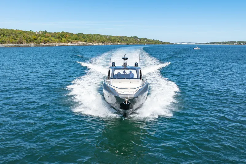 Slide: The Image of 2023 Azimut Verve 47 yacht cruising on open water, surrounded by scenic coastline. - 41