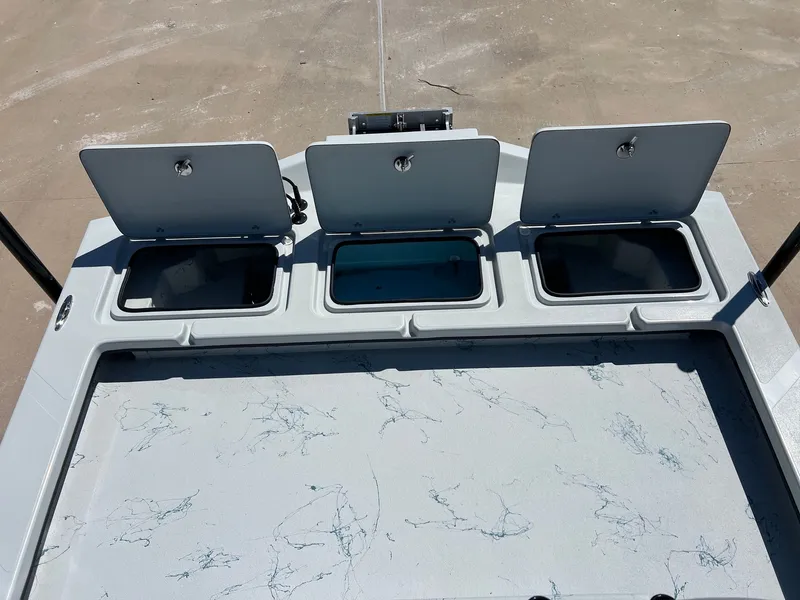 Slide: The Image of Three open storage compartments on a 2026 Shoalwater 23' Catamaran. - 23