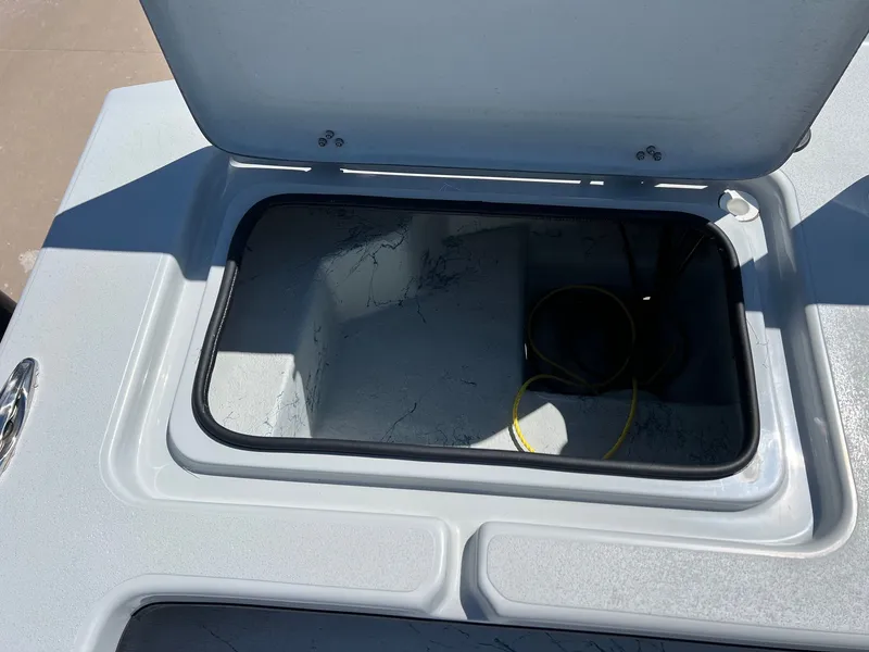 Slide: The Image of Open storage compartment on a 2026 Shoalwater 23' Catamaran. - 26