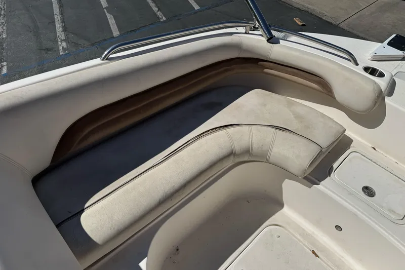 Slide: The Image of 2007 Hurricane SunDeck 217 OB boat interior with white cushioned seating. - 10