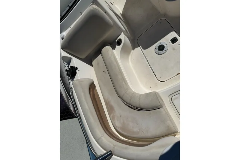 Slide: The Image of 2007 Hurricane SunDeck 217 OB boat interior with white seating and storage compartments. - 11