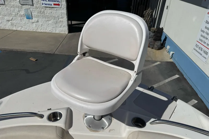 Slide: The Image of White seat on a 2007 Hurricane SunDeck 217 OB boat, near a marine service shop. - 12