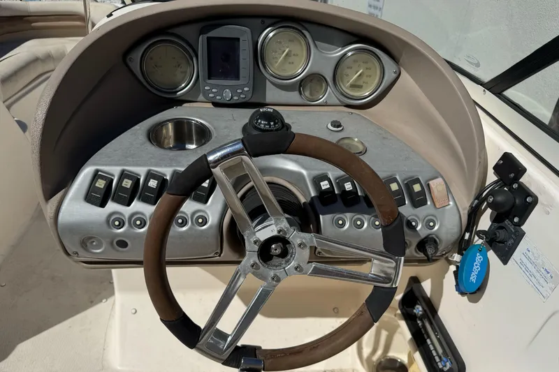 Slide: The Image of 2007 Hurricane SunDeck 217 OB boat dashboard with steering wheel and control panel. - 14