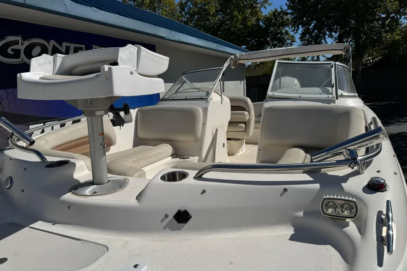 Slide: The Image of 2007 Hurricane SunDeck 217 OB boat with seating and steering console, docked outdoors. - 3