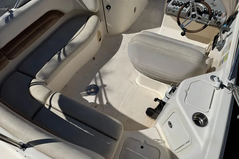 Slide: The Image of 2007 Hurricane SunDeck 217 OB boat interior with seating and steering console. - 5