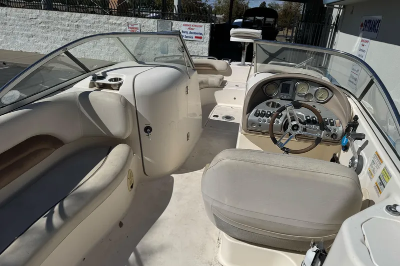 Slide: The Image of 2007 Hurricane SunDeck 217 OB boat interior with steering wheel and seating area. - 6