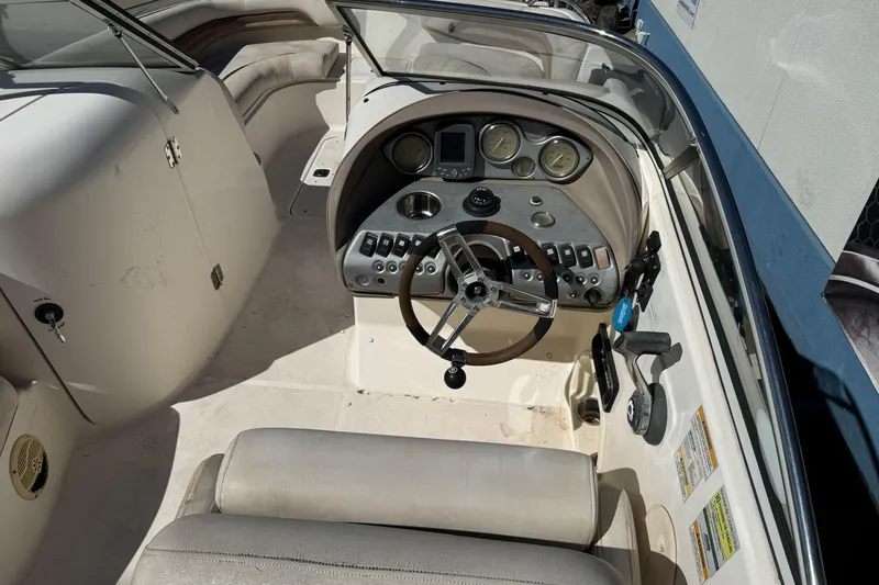 Slide: The Image of 2007 Hurricane SunDeck 217 OB boat cockpit with steering wheel and control panel. - 7