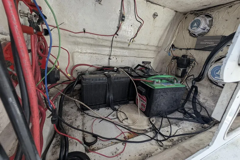 Slide: The Image of Electrical wiring and batteries inside a 1989 Intrepid 29 boat compartment. - 11