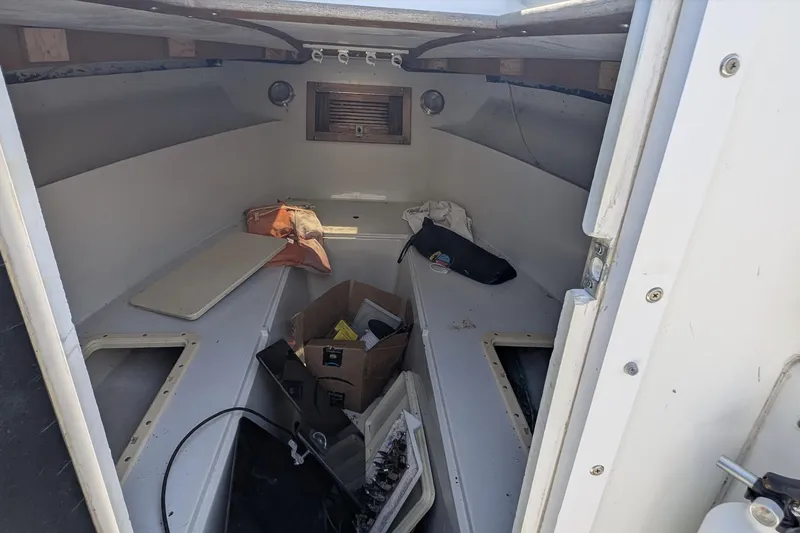 Slide: The Image of Interior of a 1989 Intrepid 29 boat, showing storage and seating area. - 6