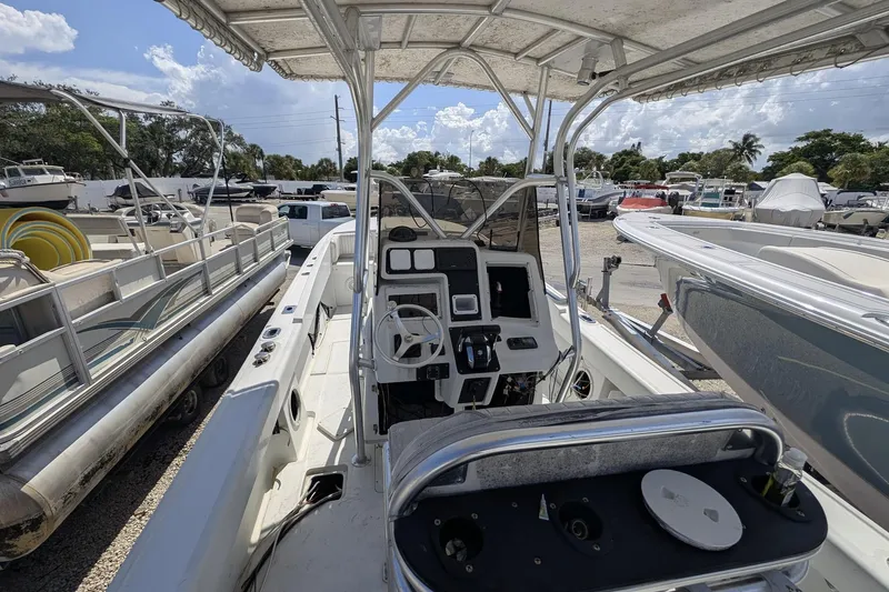 Slide: The Image of 1989 Intrepid 29 boat interior with steering console, parked among other boats. - 8