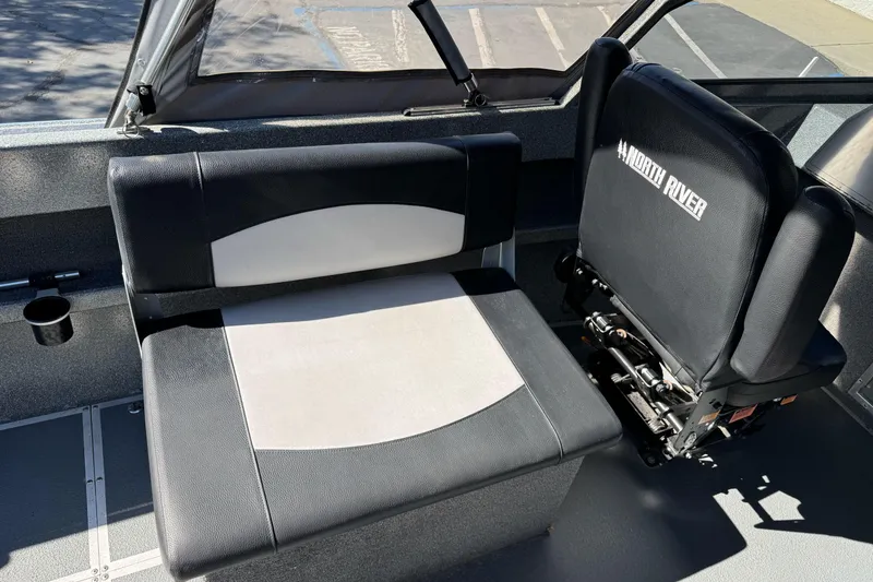 Slide: The Image of 2023 North River 21 X 84 Seahawk interior seating with black and white upholstery. - 15