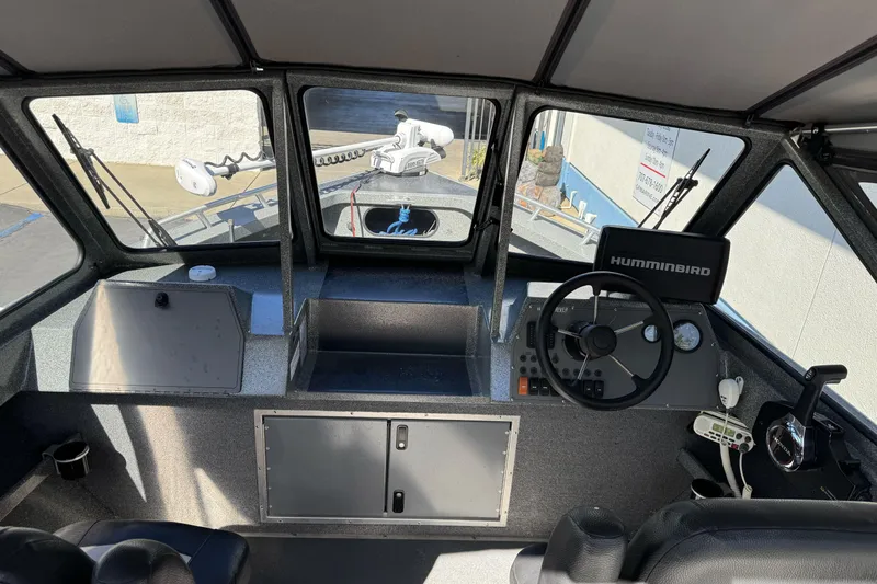Slide: The Image of Interior view of 2023 North River 21 X 84 Seahawk boat cockpit with steering wheel and controls. - 16