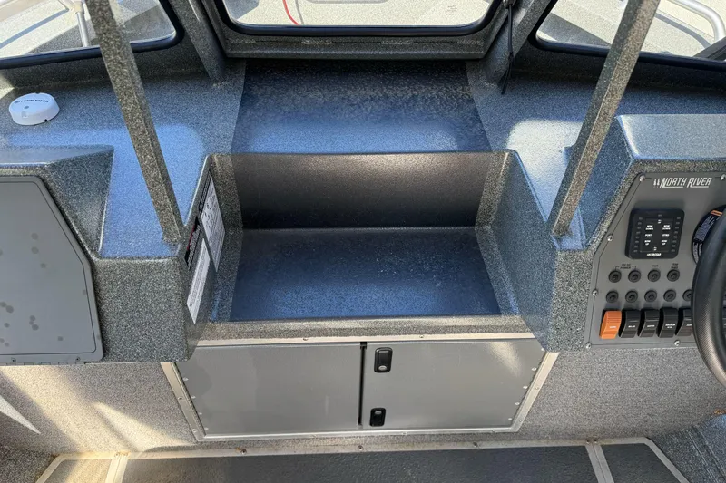 Slide: The Image of 2023 North River 21 X 84 Seahawk boat dashboard with control panel and storage. - 22