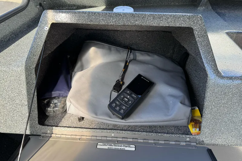 Slide: The Image of Storage compartment in 2023 North River 21 X 84 Seahawk boat with bag and device. - 23
