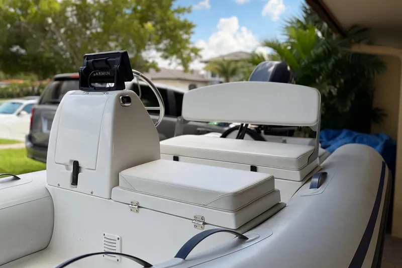 Slide: The Image of 2018 AB Inflatables Mares 10 VSX boat with Garmin navigation, parked outdoors. - 2