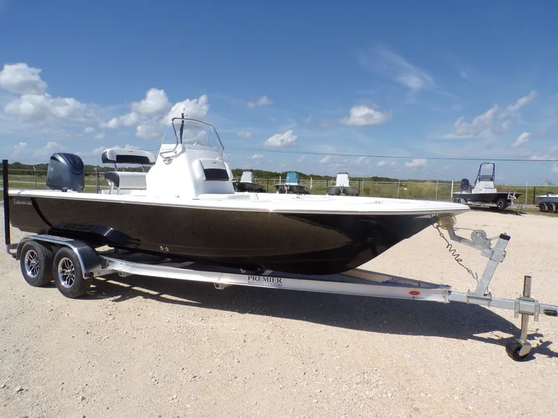 Slide: The Image of 2026 Tidewater 2110BMT boat on trailer under blue sky. - 26