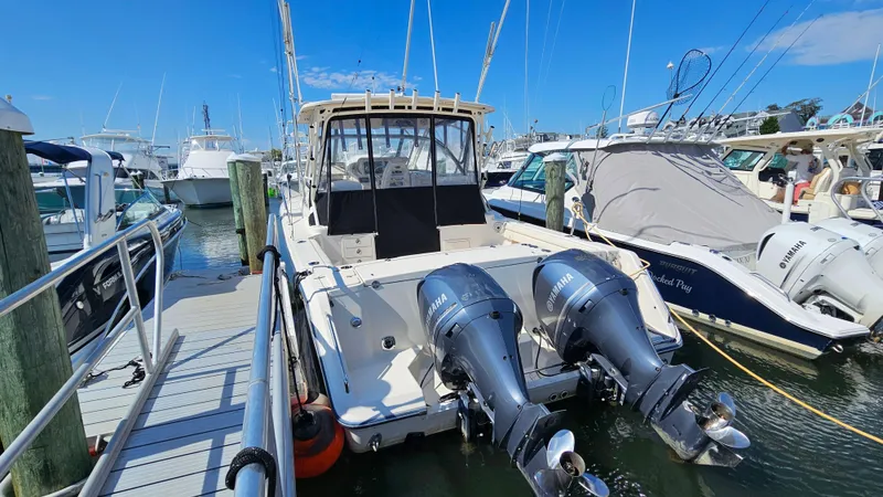 Slide: The Image of 2016 Grady-White Express 330 boat docked with twin outboard engines. - 11