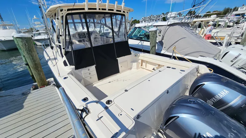 Slide: The Image of 2016 Grady-White Express 330 boat docked with twin Yamaha engines. - 12