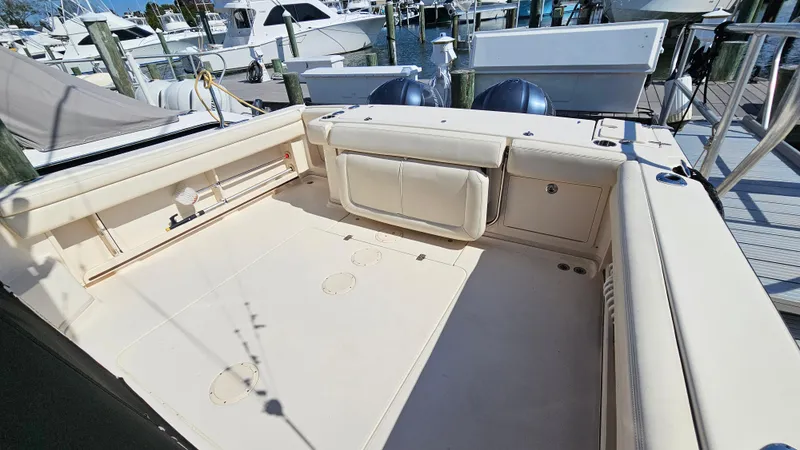 Slide: The Image of 2016 Grady-White Express 330 boat deck with seating, docked at marina. - 13