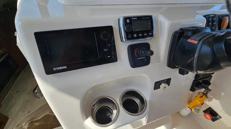 Slide: The Image of 2016 Grady-White Express 330 dashboard with Yamaha controls and electronics. - 28