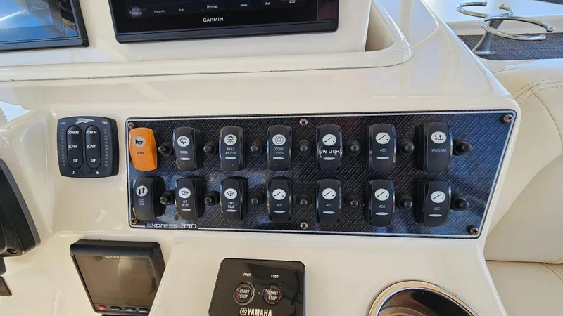 Slide: The Image of Control panel of 2016 Grady-White Express 330 boat with various switches and displays. - 31