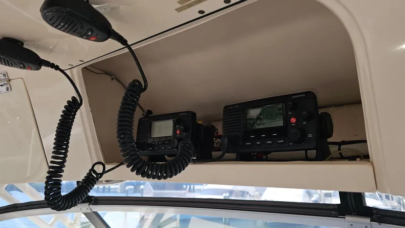 Slide: The Image of 2016 Grady-White Express 330 boat communication equipment with mounted radios and microphones. - 33