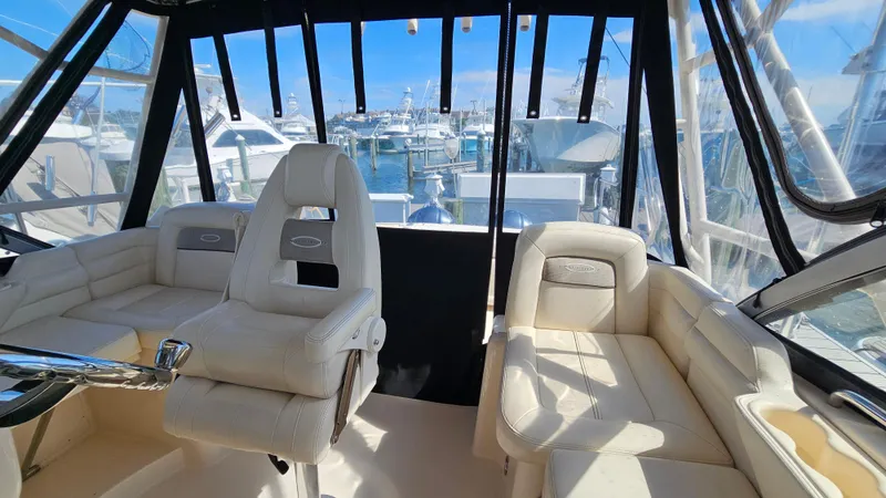Slide: The Image of 2016 Grady-White Express 330 boat interior with plush seating and marina view. - 35